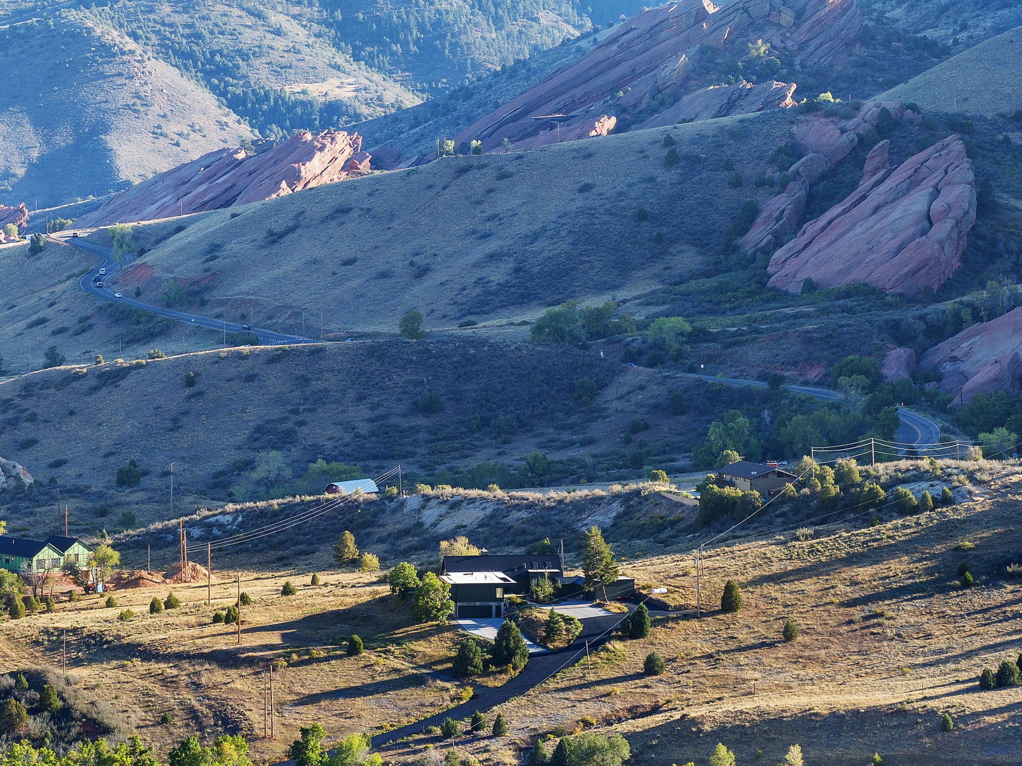 Aerial view of the red sandstone formations of Red Rocks Park, with the Hideaway on the hillside below