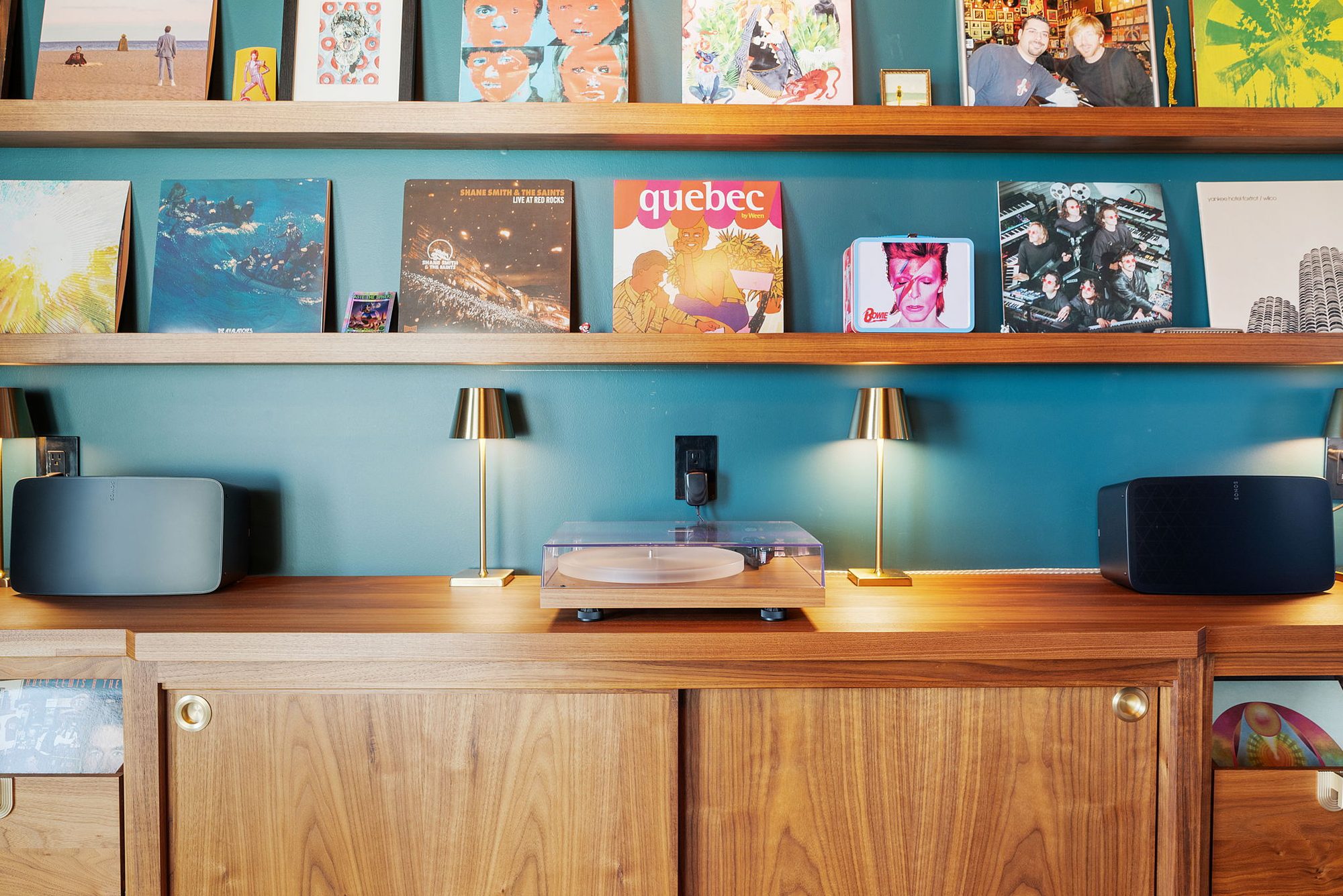 Turntable and records on a wood sideboard in the Music Lounge