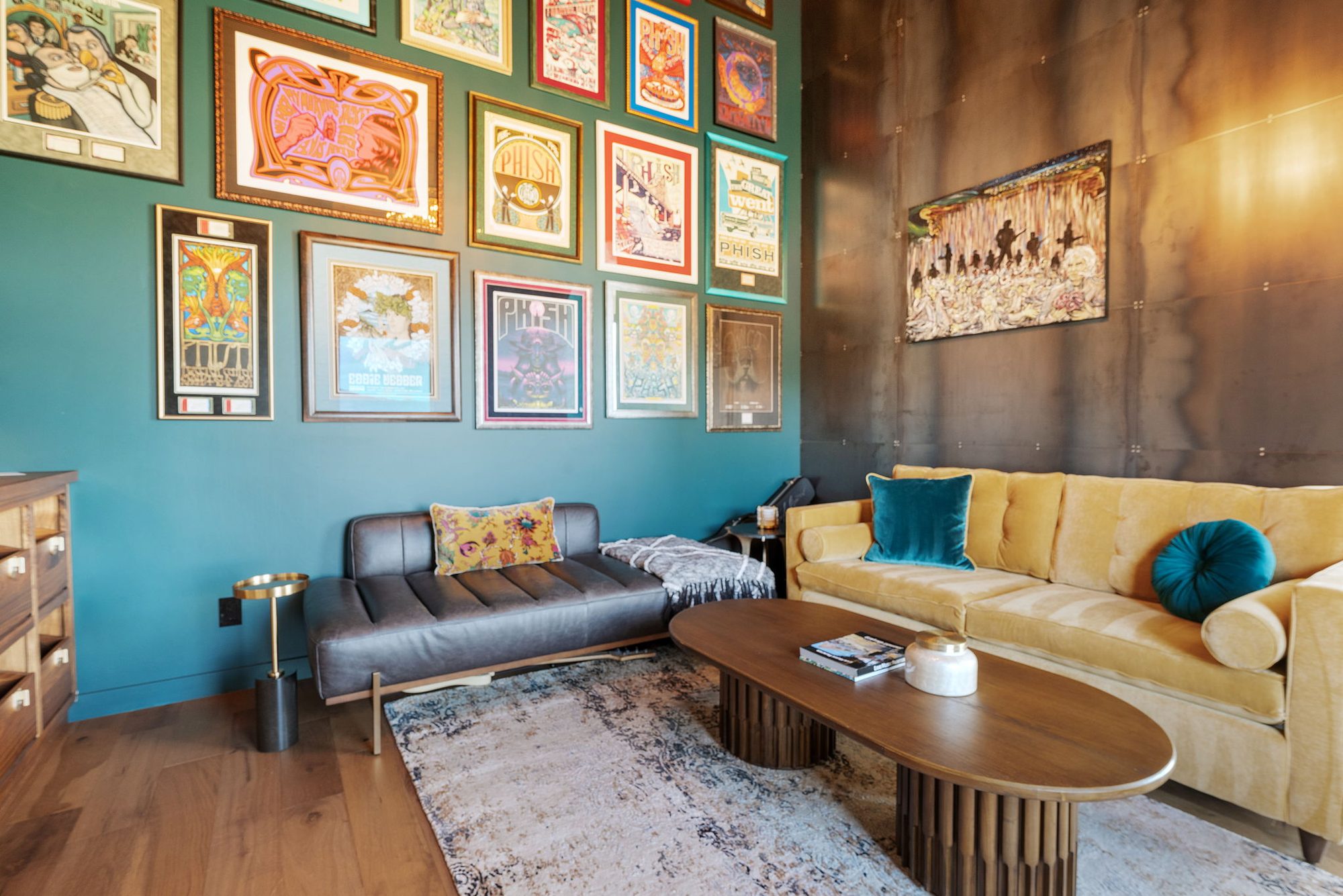 Music Lounge seating area with a yellow velvet sofa, leather bench and a rusted metal wall